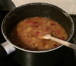 Roughly chopped plums with sugar in saucepan